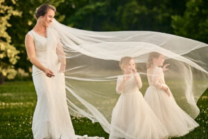 Bride veil over flower girls
